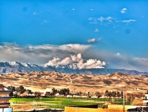 view-north-from-the-roof-of-our-home-in-jalalabad-green-fields-the-kabul-river-hidden-golden-hills-and-then-the-beginning-of-the-hindu-kush
